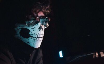 cyber hacker wearing a skull mask phishing attacks