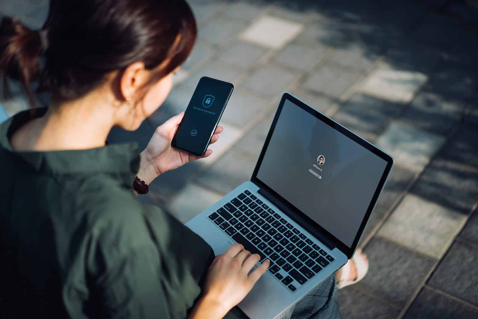 woman using phone and computer cloud security